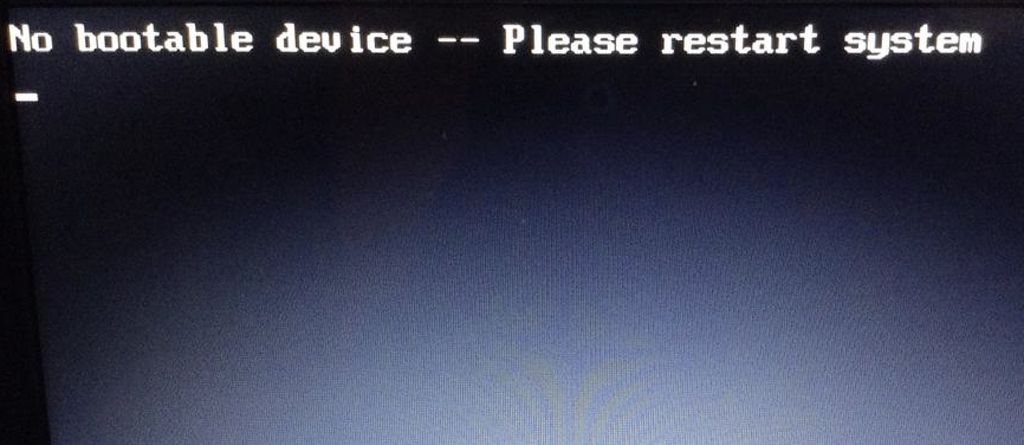 A computer screen displaying a message ‘No bootable device -- Please restart system’.